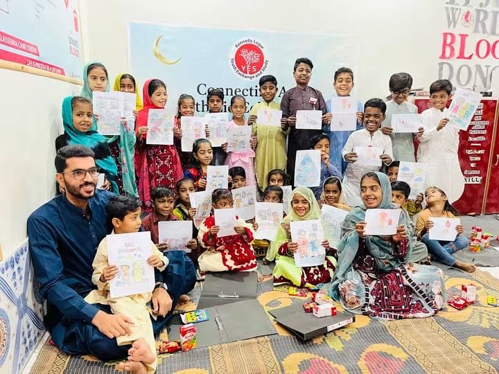 Thalassemia children holding their drawings at a Psycho-Social Well-Being House session