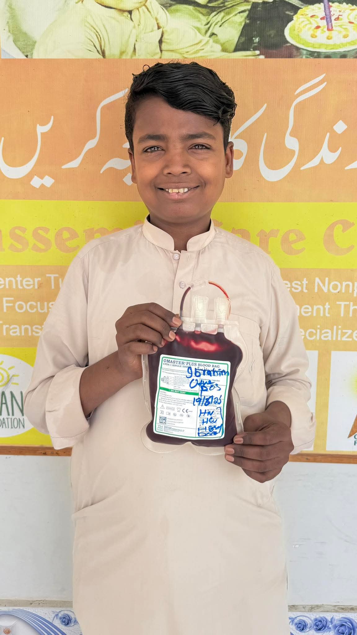 Fahad Rashid smiling with a blood bag at KTCC