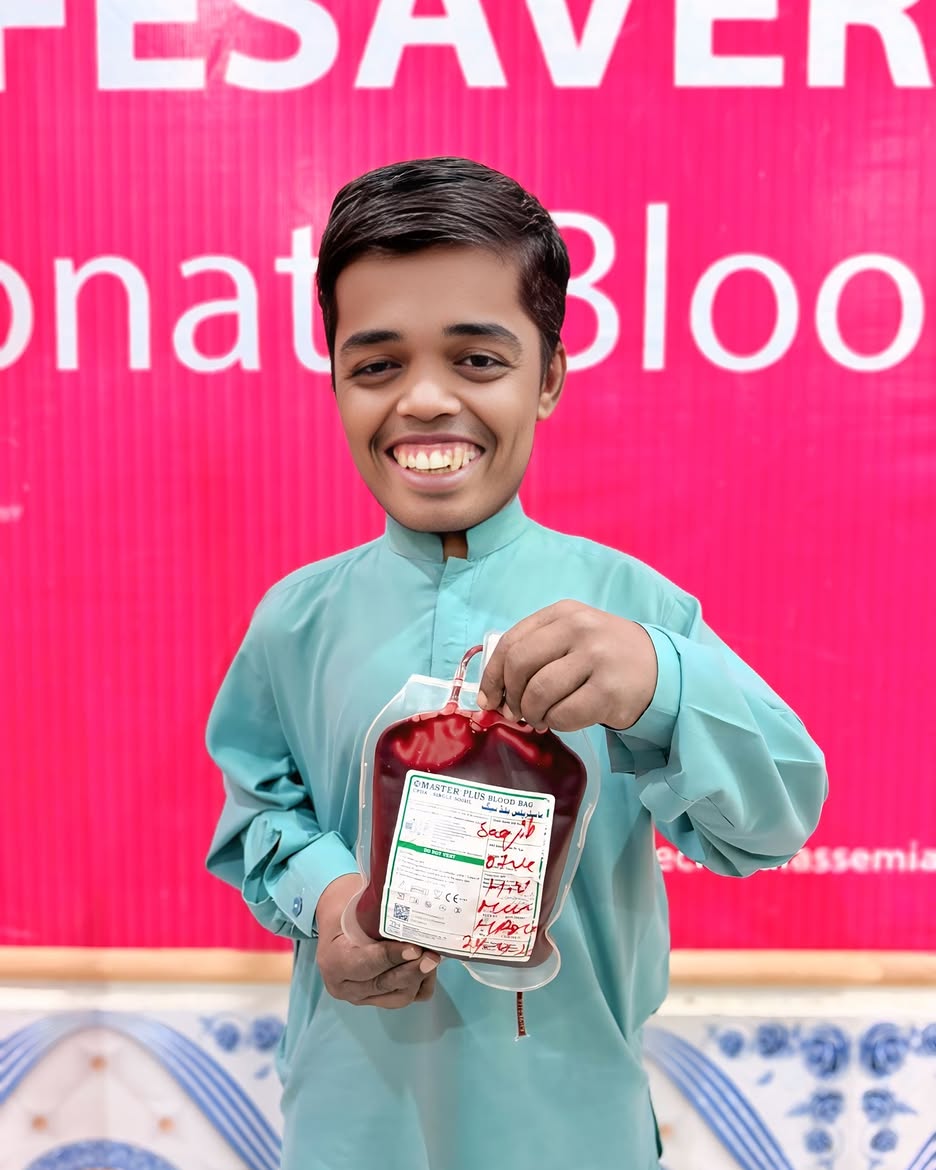 Shoaib Javed holding a blood bag at KTCC