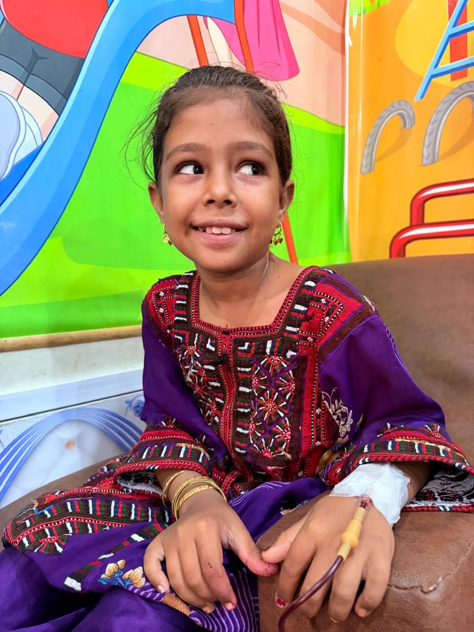 Mehtab Baloch smiling during her transfusion at KTCC